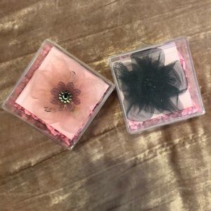 Two Tarina Tarantino hair clips. Black and pink.